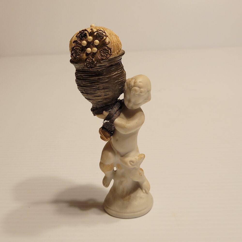 Vintage child cherub figurine with vase